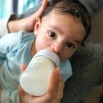adorable baby eating a bottle of the best organic baby formula