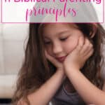 little girl reading the bible thanks to biblical parenting principles