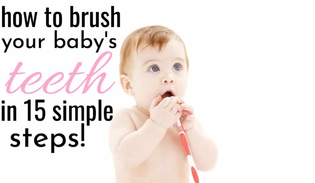 baby holding a toothbrush learning how to brush a baby's teeth