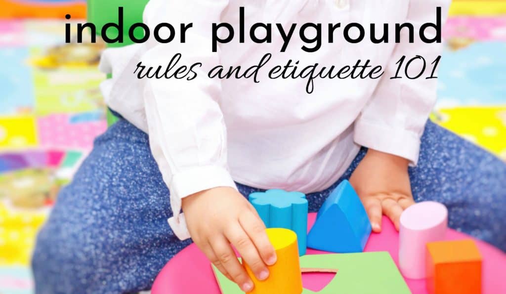 little girl following indoor play area rules and etiquette while playing with colorful blocks on the floor