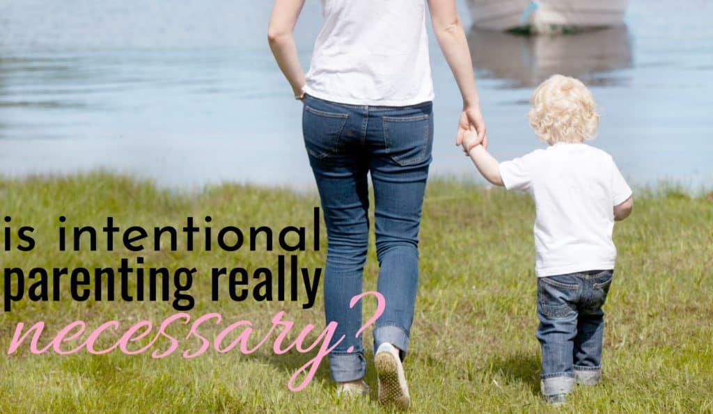 mom intentionally parenting her son as they walk hand in hand by a lake