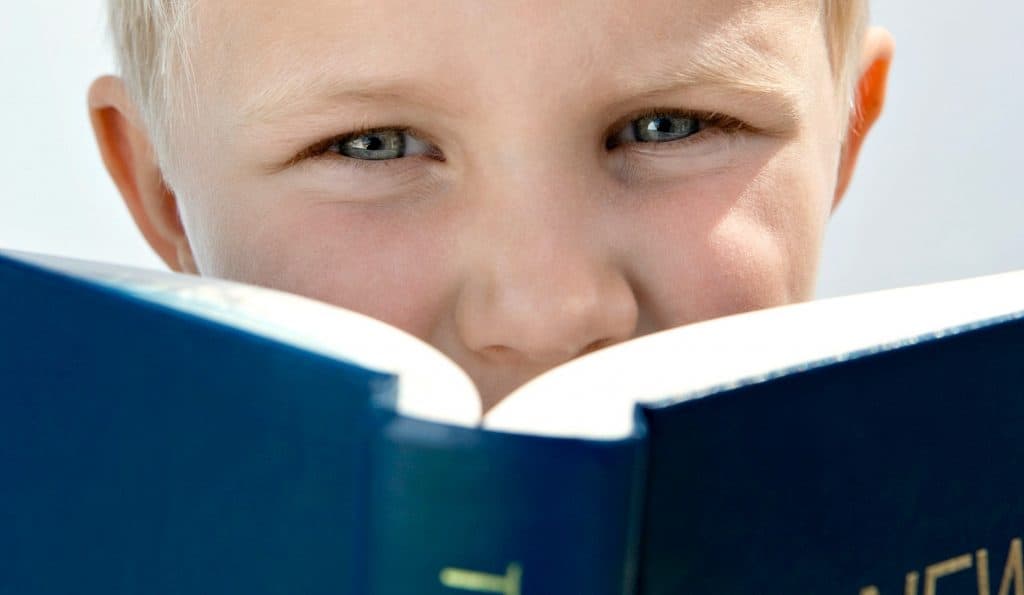 little boy reading the bible learning obedience is better than sacrifice