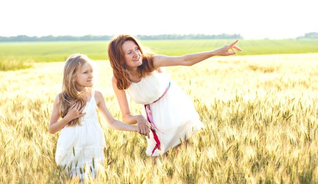 mom and daughter in wheat field pursuing parenting goals