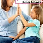 mom using positive reinforcement to change behavior by giving cute daughter a high five