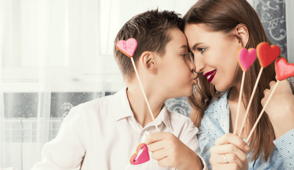 two kids playing with a red heart while celebrate Valentine's Day with your kids