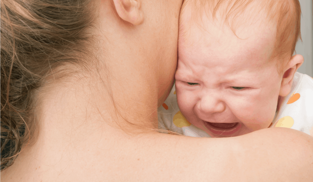 baby crying on moms shoulder during witching hour for baby